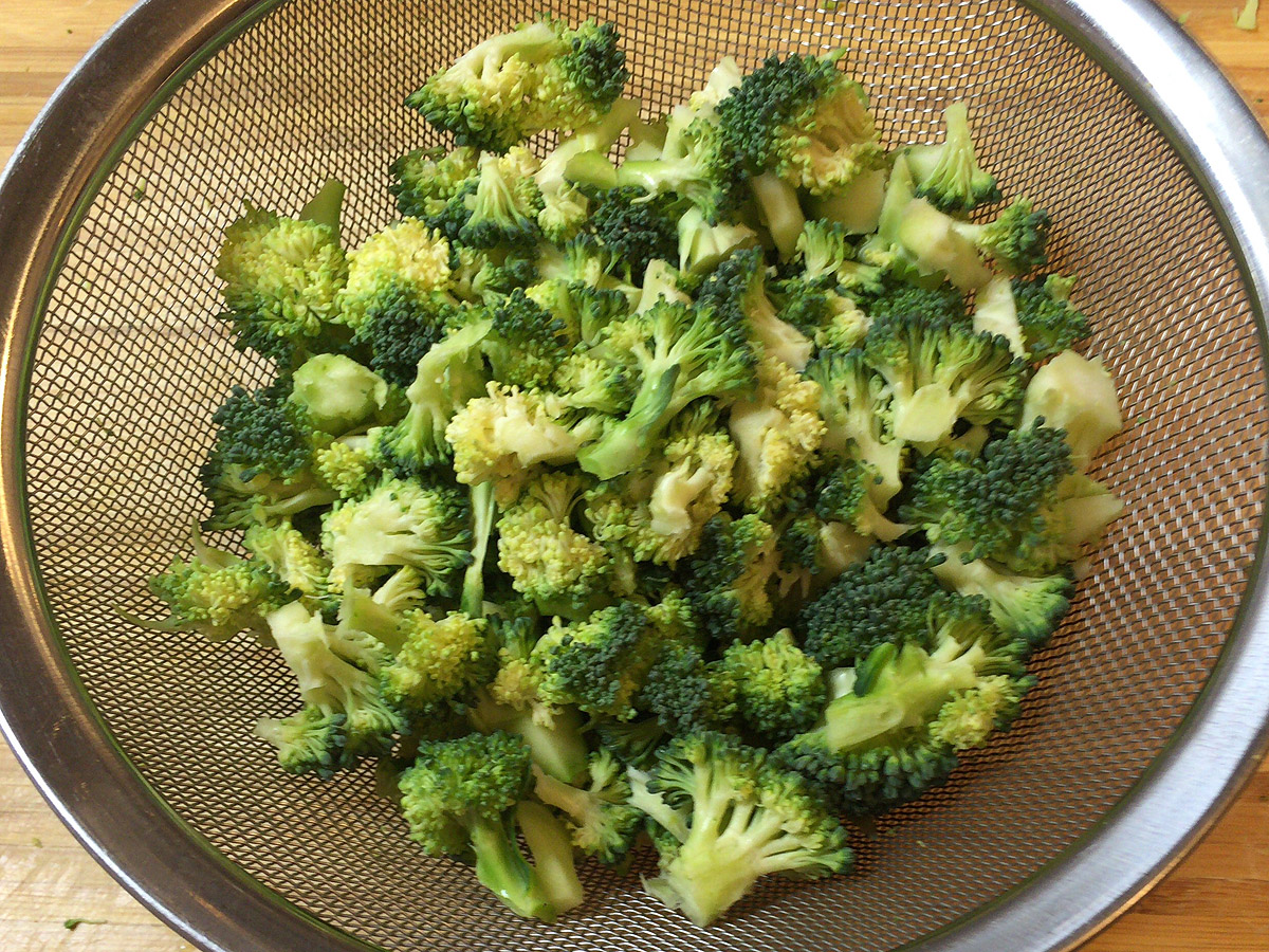 ブロッコリーはそのまま刻むと花芽がボロボロになるので、茎の方に切れ目を入れて手で裂くときれいに小さくできる。