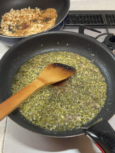 アーリオオーリオを作り、オイルサーディンを加える。向こうにあるのは炒って準備したパン粉。