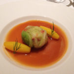 「キャベツで包んだオマール海老　ブイヤベース風ソース　サフランの香りのちいさなジャガイモ」。どこか素朴さを感じる料理。一皿目でもっとオマールを食べたいなと思ったら、ここに出てきた。オマールは小さめにカットされているが、弾力あるオマールならではの食感と風味はそのまま。ソースはブイヤベース風で、先のコンソメジュレとは異なった味わい。